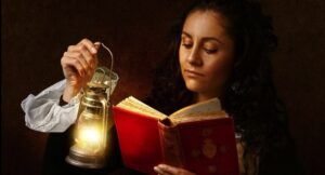 light-skinned woman reading by an old fashioned lamp