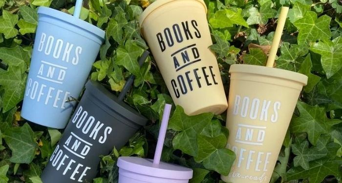 collection of books and coffee tumblers on a green ivy background