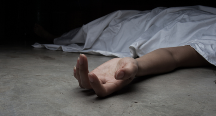 a photo of a white woman, presumably dead, under a sheet, with only her limp hand visible