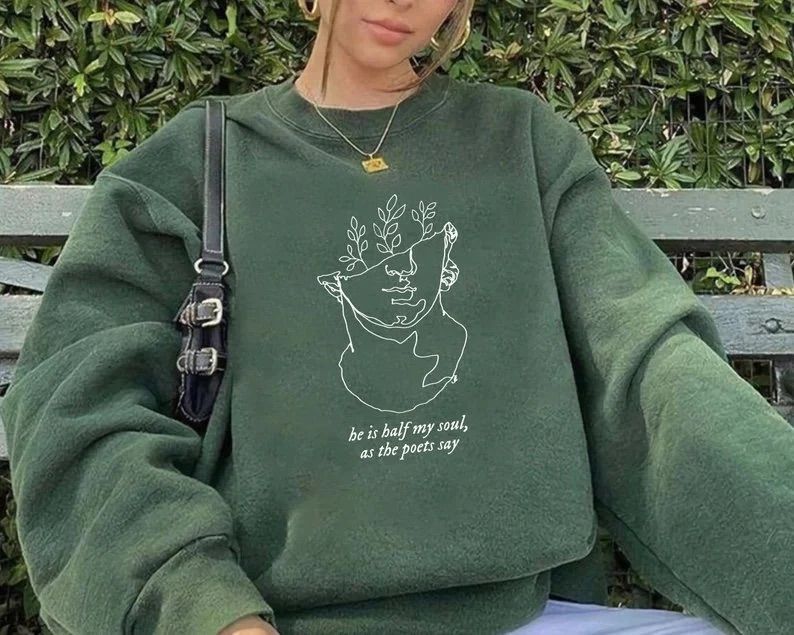 Woman in green Song of Achilles Sweatshirt that says " He is Half My Soul As The Poets Say" 