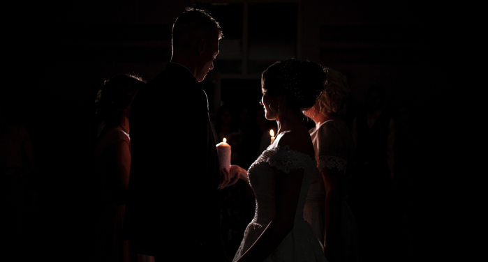 a groom and bride in candlelight