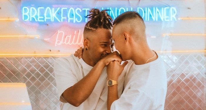 image of two queer brown people embracing
