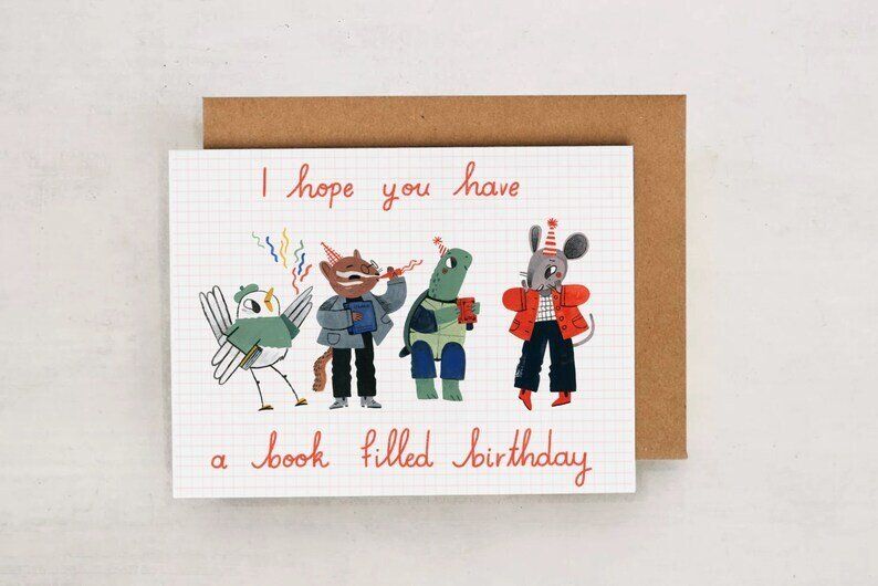 Birthday card that says I Hope You Have a Book Filled Birthday with dancing, partying animals.