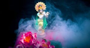 Hindu statuette playing a flute with smoke billowing around it