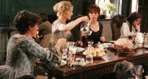 a still from Pride and Prejudice showing them having tea