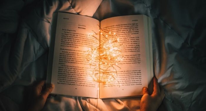 book open with fairy lights between its pages