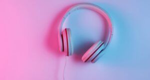 Image of headphones on pink and blue background