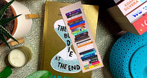 a photo of a bookmark showing an illustration of a stack of YA books from A to Z