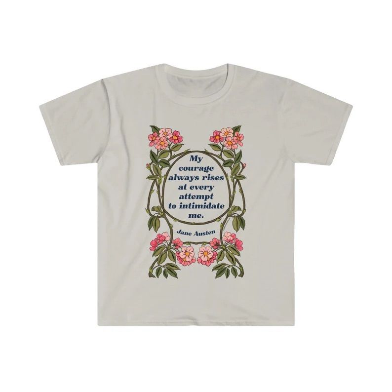 Photo of a white t-shirt with the quote My courage always rises at every attempt to intimidate me surrounded by leaves and flowers