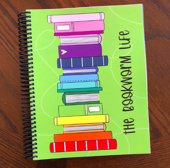 Green spiral bound planner with a graphic of a rainbow book stack and the word "the bookworm life"