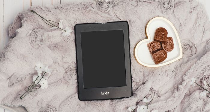 Image of a Kindle beside a plate of chocolate