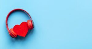 image of a red heart with red headphones around it on a blue background