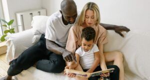 Image of multiracial family reading together