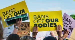 several people holding up signs hat read "Bans off Our Bodies" at a pro-choice rally