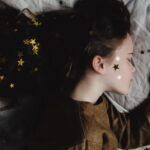 sleeping kid with gold stars in hair