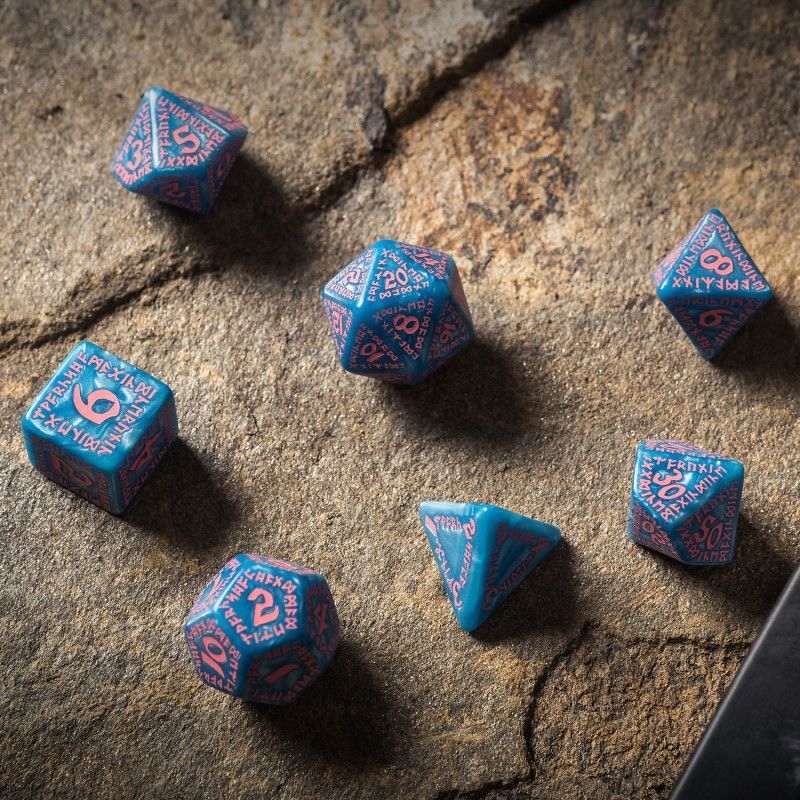 A photo of a set of seven blue dice with pink runes and numbers on the faces. 