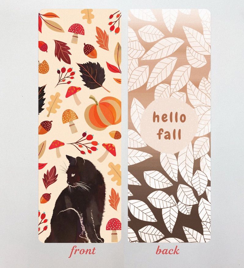 Image of a black cat bookmark with pumpkins, acorns, mushrooms, and leaves. The back of the bookmark has the words "hello fall" in a circle surrounded by leaves. 