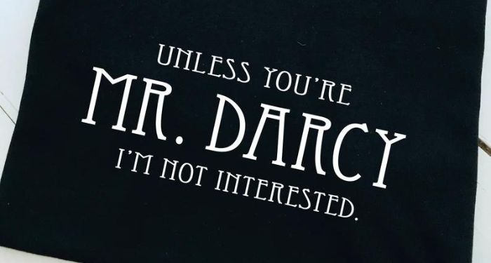 Photo of a black t-shirt with the quote 'Unless you're Mr. Darcy I'm not interested' printed in white letters.