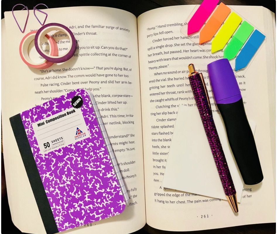 Image of a book annotation kit which includes a notebook, pen, highlighter, sticky tabs, notepad, washi tape, and paper clips. It is in a purple colorway. 