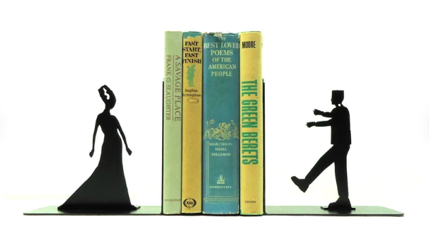 Cut metal bookends of Frankenstein's monster and his bride holding up four books
