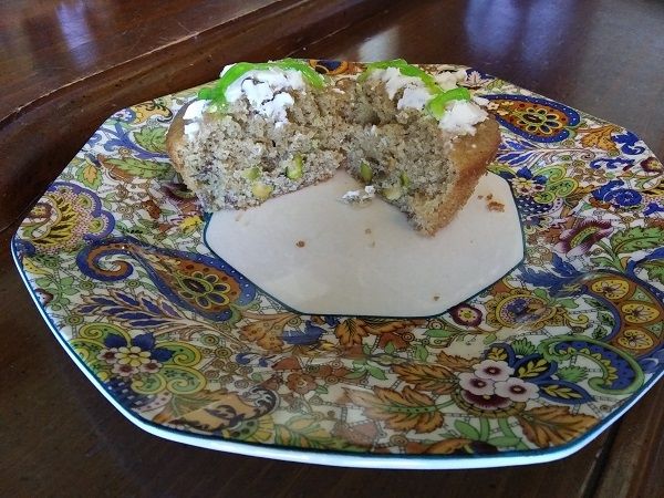 Author photo of a pistachio muffin with cream cheese and green icing