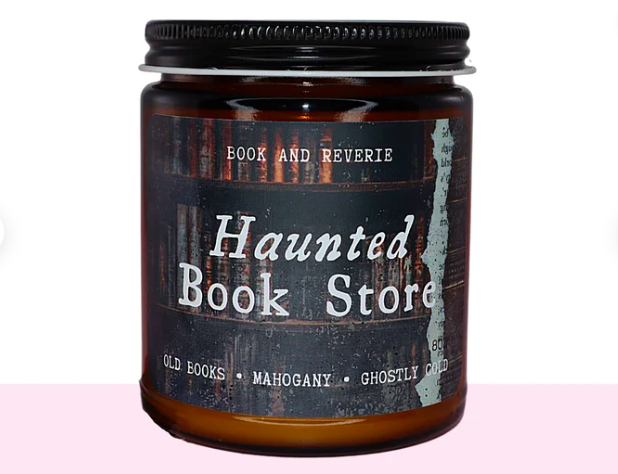 A candle in a jar that is Haunted Book Store scented. The scents are described as old books, mahogany, and ghostly cold.