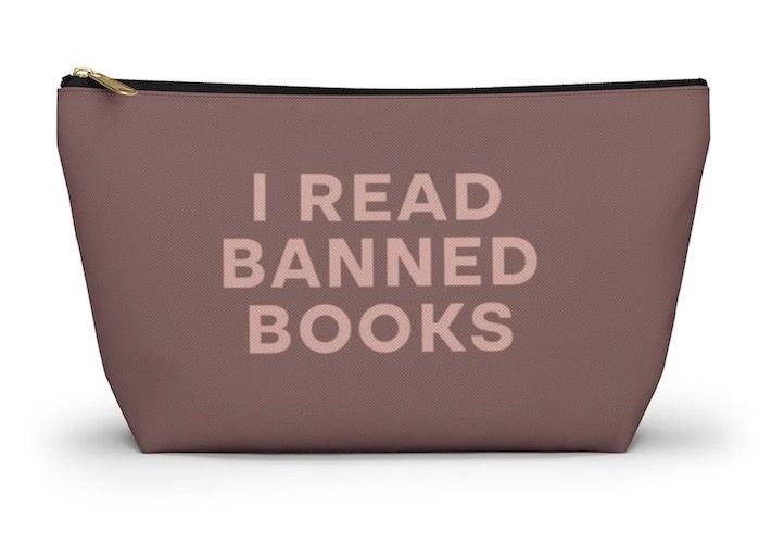 a chocolate brown pouch with the words "I Read Banned Books" in pink text