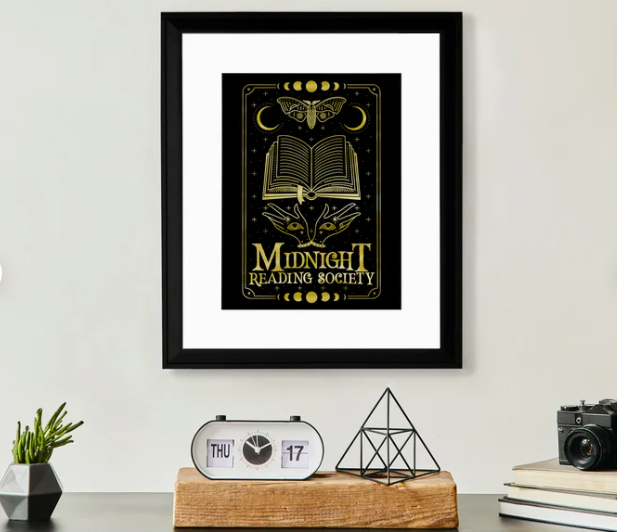A framed dark print with moons and books that says Midnight Reading Society