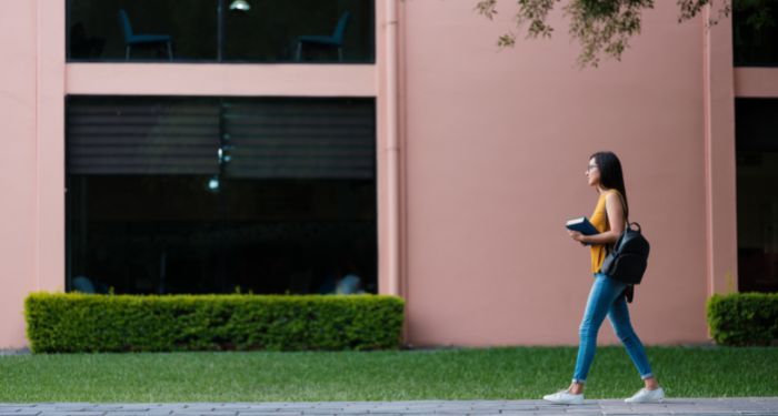 woman walking on campuswoman with lightly-tanned skin walking on campus