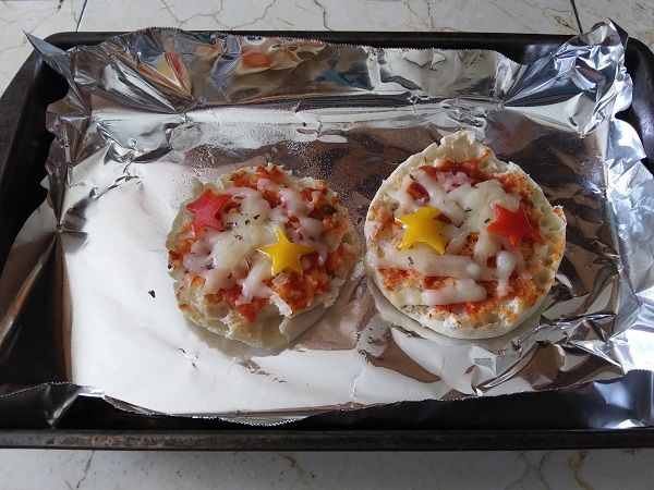 Author photo of an English muffin pizza with red and yellow stars cut from peppers
