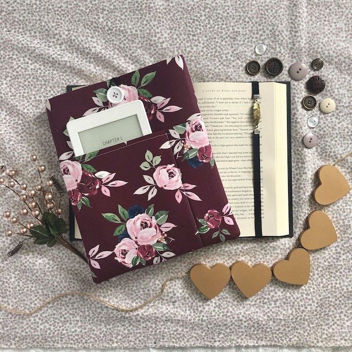 burgundy floral book sleeve with a picked for a tablet ore reader positioned next to an open book