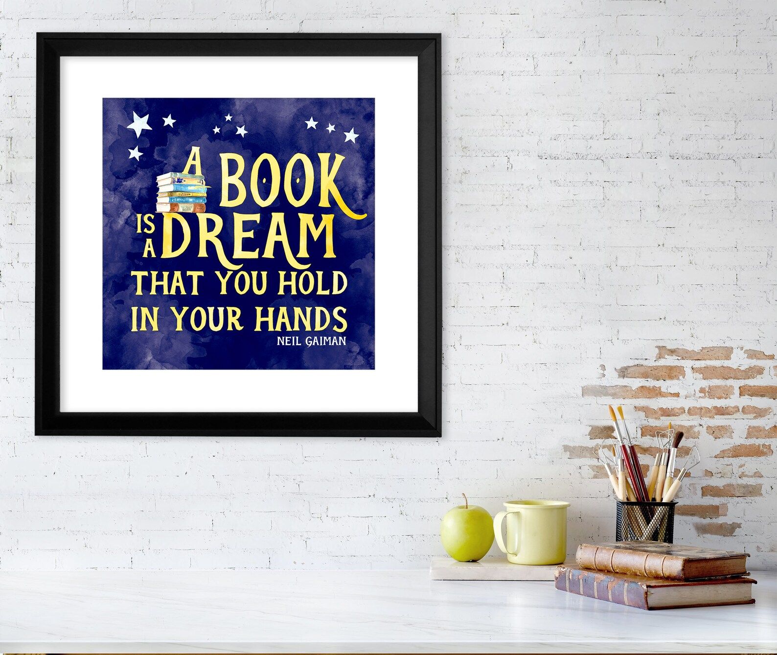 a photo of a poster with the text  "A book is a dream that you hold in your hands." - Neil Gaiman 