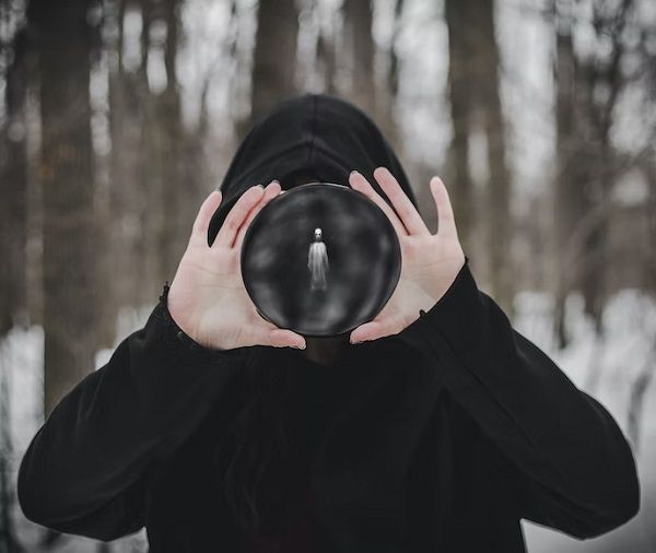 a photo of someone holding a circle with a ghostly figure in it