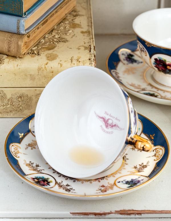 teacup with the text YOU HAVE BEEN POISONED on the bottom of it to be revealed when the teacup is empty