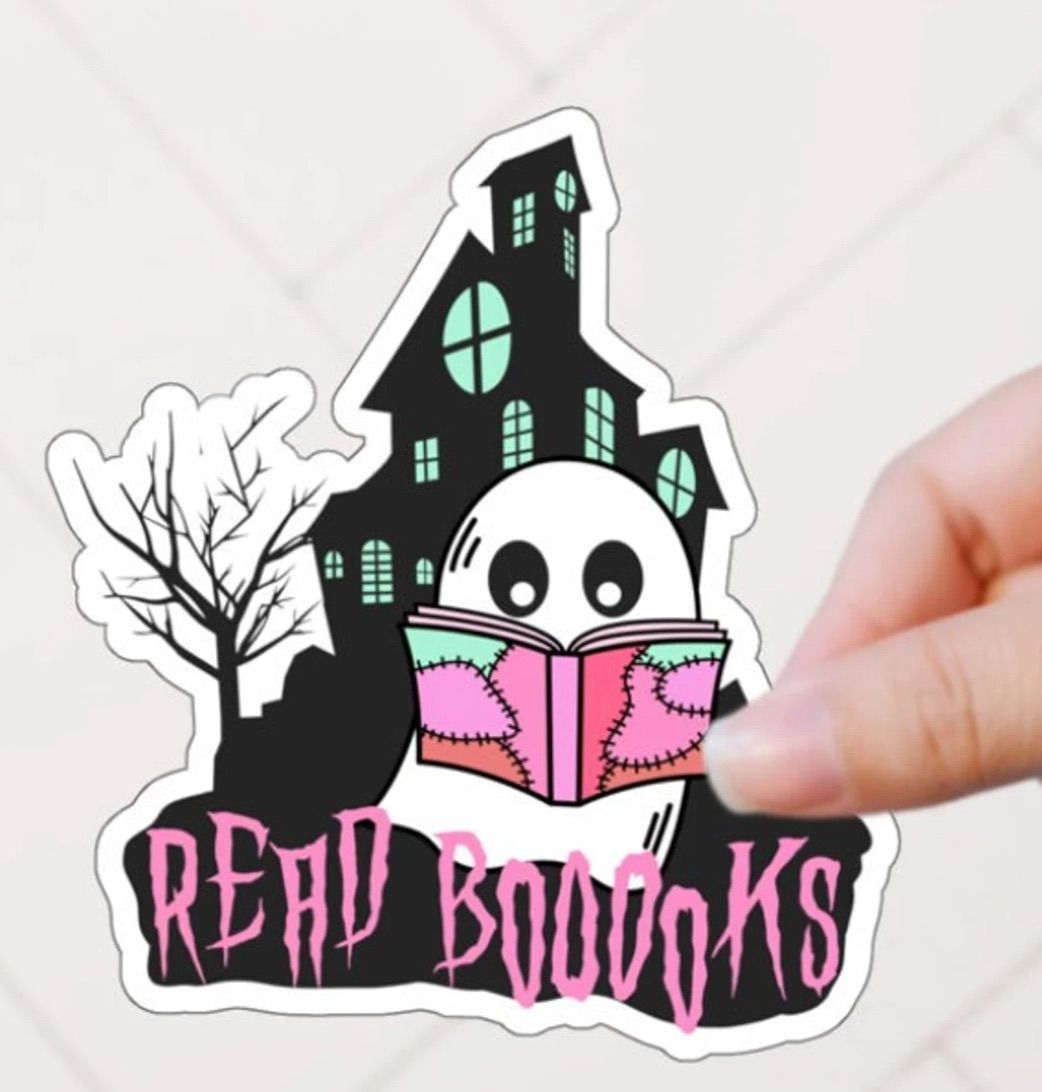 Image of a sticker featuring a ghost reading a pink book in front of a haunted house. It says "read boooks" in pink font. 