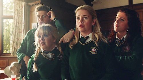 Derry Girls screenshot of three teens in catholic school uniforms and one boy