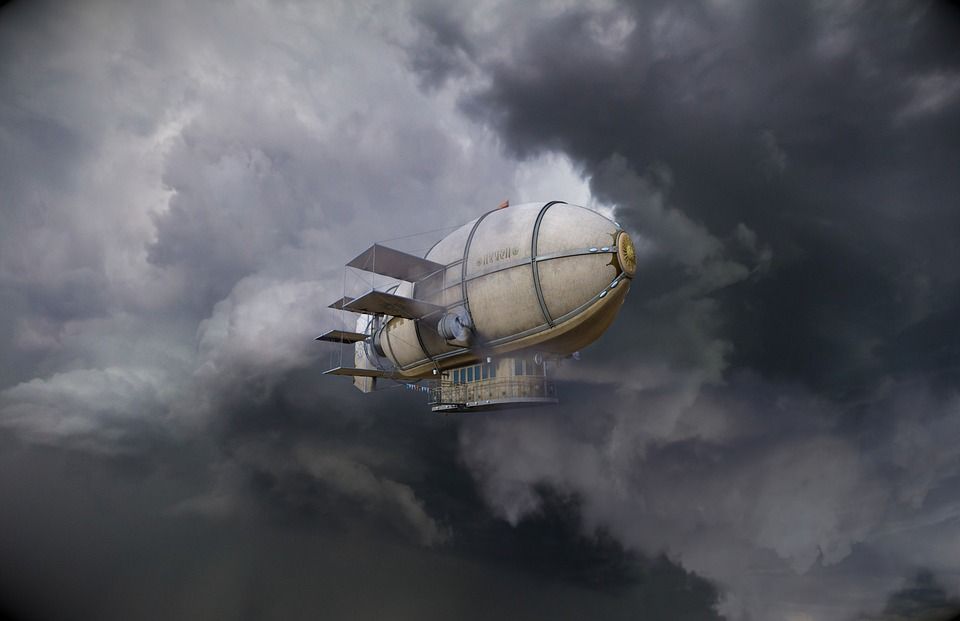 A steampunk-style airship, with a balloon above and a travel compartment below, flies across a stormy sky full of grey clouds.