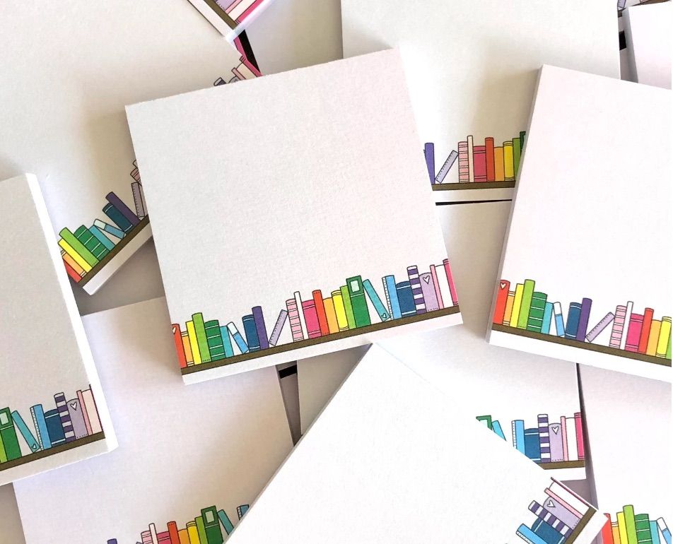 Stack of sticky notes each featuring a colorful bookshelf. 