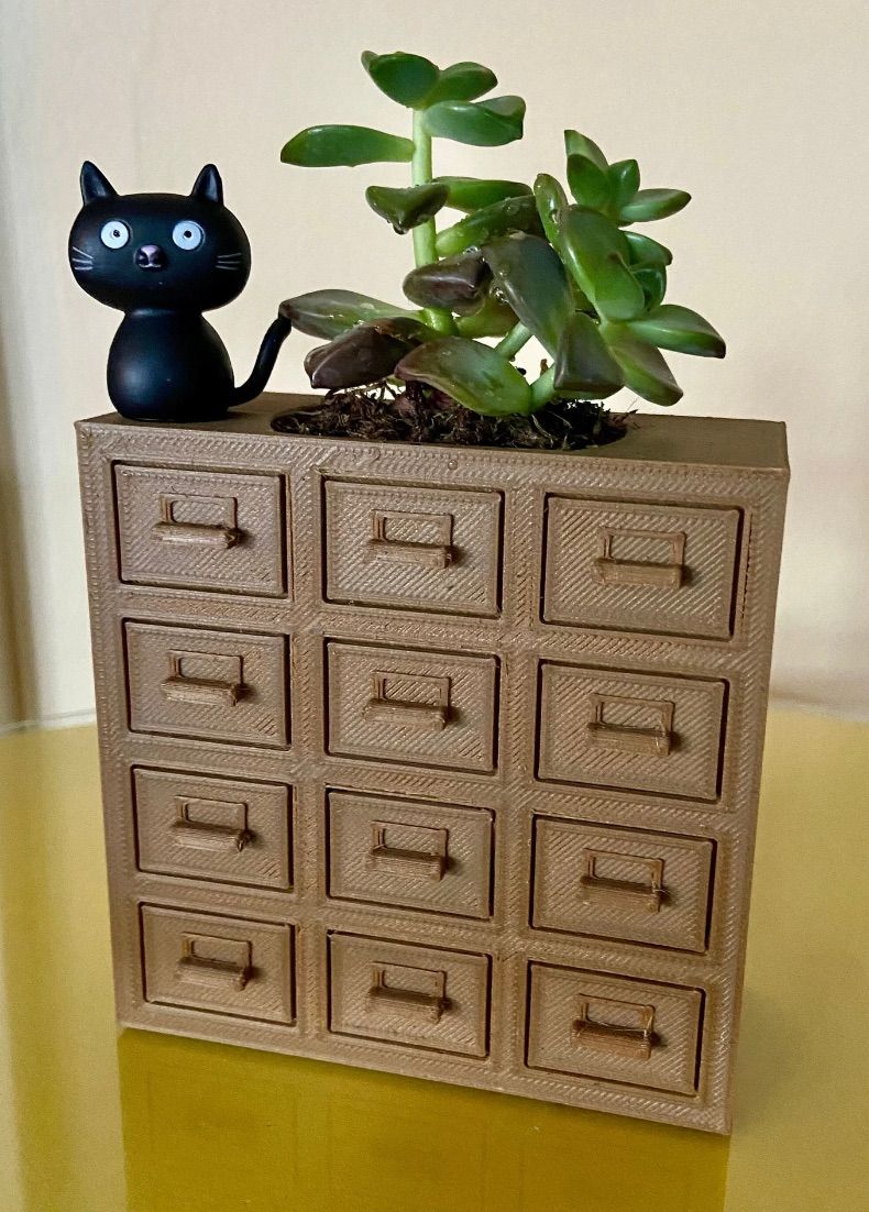 Replica card catalog featuring space for a plant on top. 