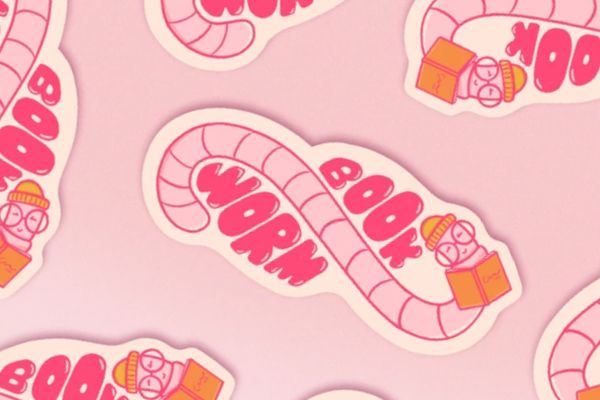 Pink illustrated stickers in the shape of a cute little worm with glasses and an orange hat reading an orange book with the words book and worm on either side of them.