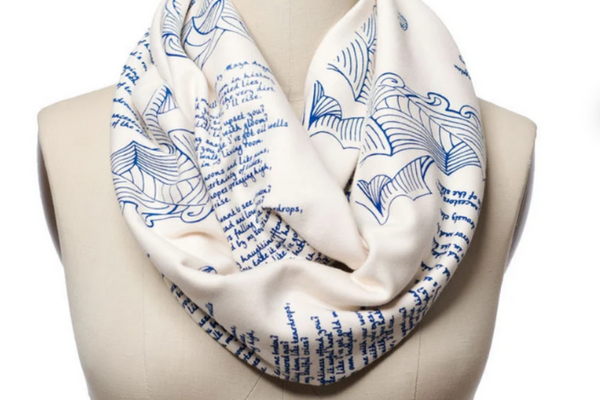 White infinity scarf featuring the text of Maya Angelou's poem, "Still I Rise" repeating across it.