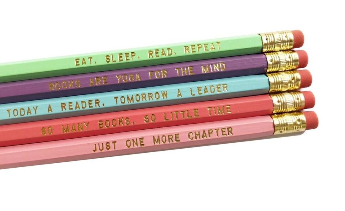 Set of pastel colored pencils, each with gold text with bookish phrases. 