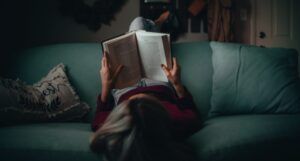 person reading upside down on a couch