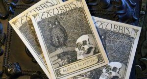 a photo of a set of three skull and owl ex libris plates