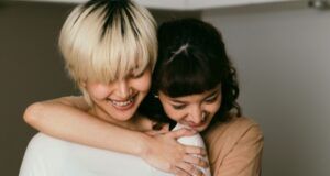 light-skinned Asian lesbian couple hugging
