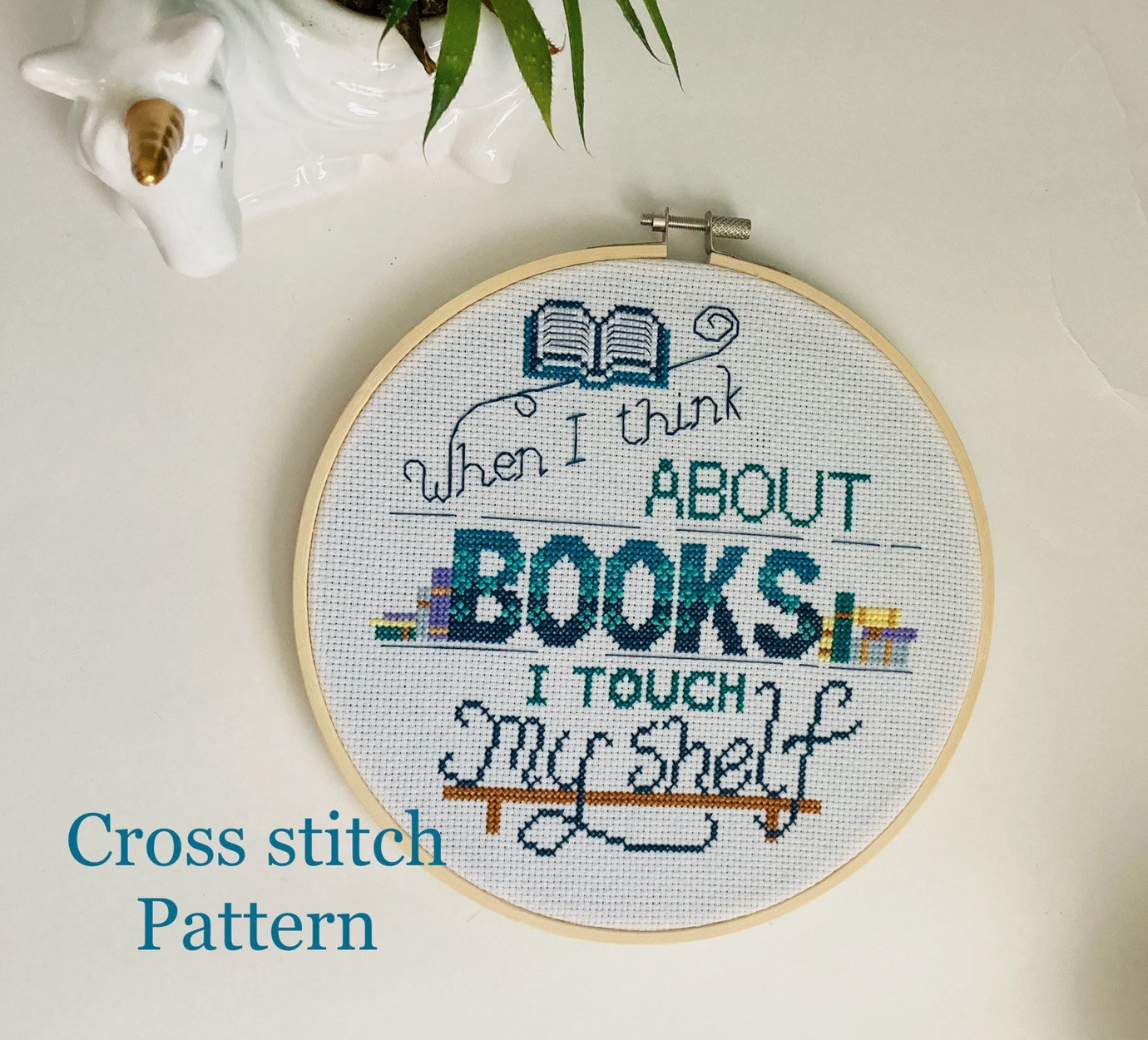 Cross stitch pattern of "When I think about books I touch my shelf"