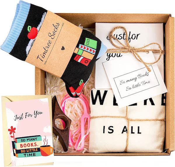 a box containing a pair of bookish socks, a tshirt, page holder, greeting card, and more | best gifts for readers 2022