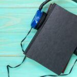 Image of a black book with blue headphones