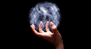 a photo of a hand with a globe of smoke in it