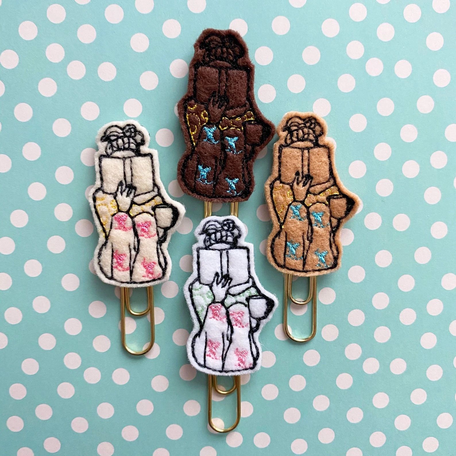 paper clips with girls reading embroidered onto felt